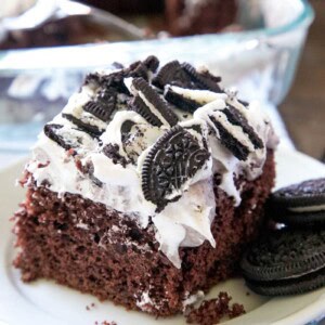 A slice of Oreo poke cake on a plate.