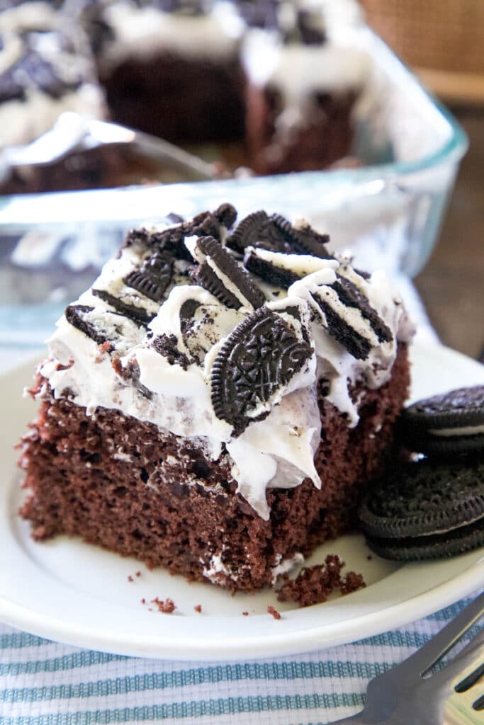 A slice of Oreo poke cake on a plate.