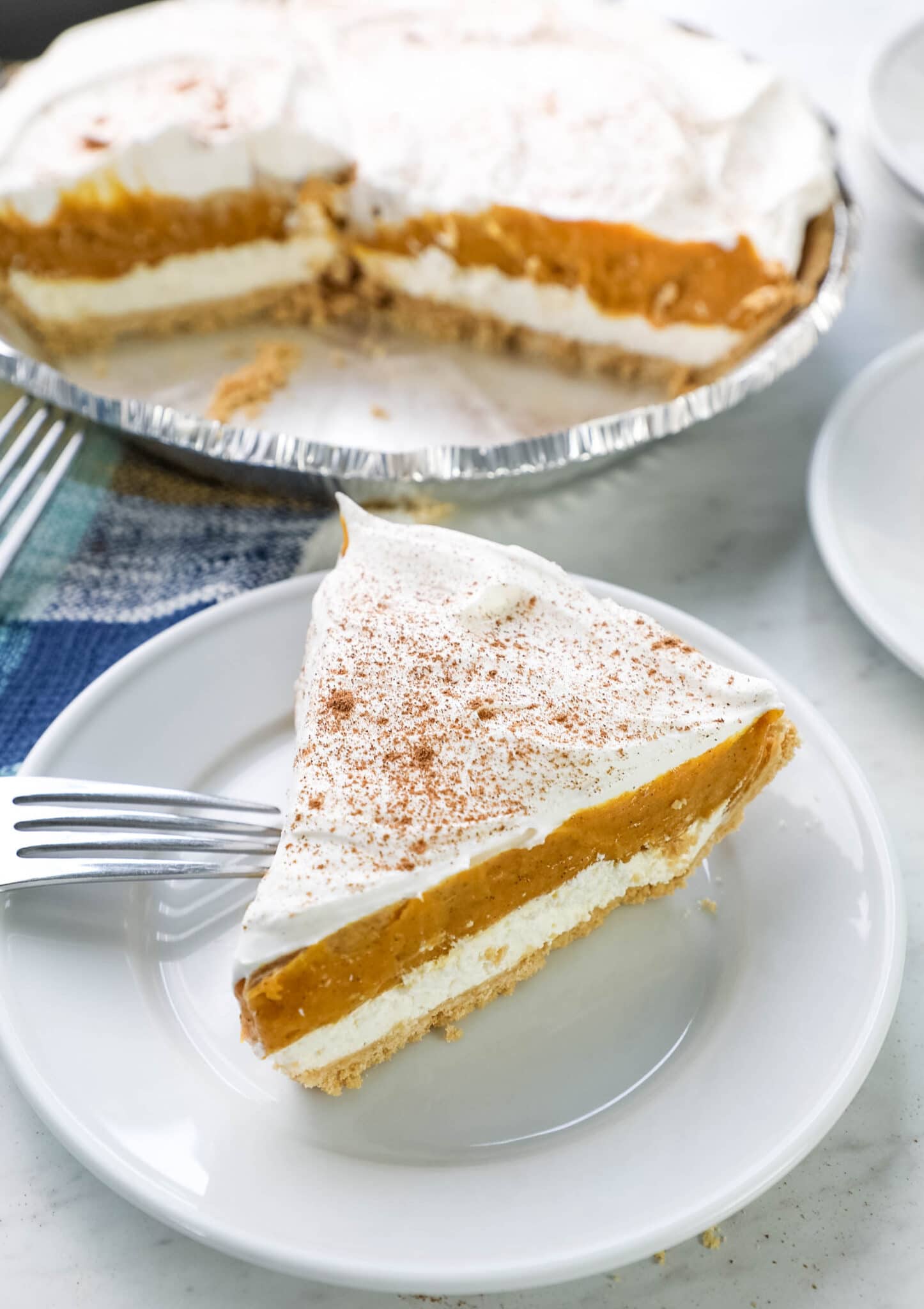 no bake pumpkin pie with cream cheese on a white plate 