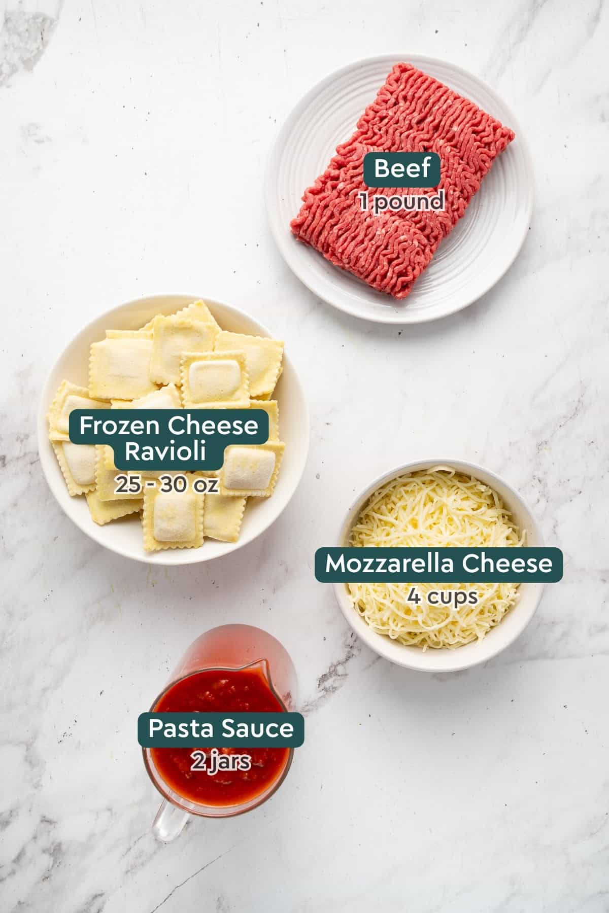 All of the ingredients for crock pot ravioli lasagna in bowls on a white countertop.