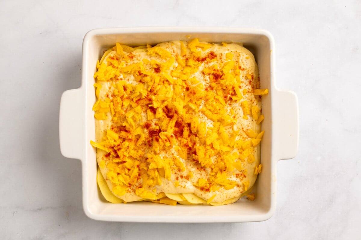 Scalloped potatoes with cheese before baking.