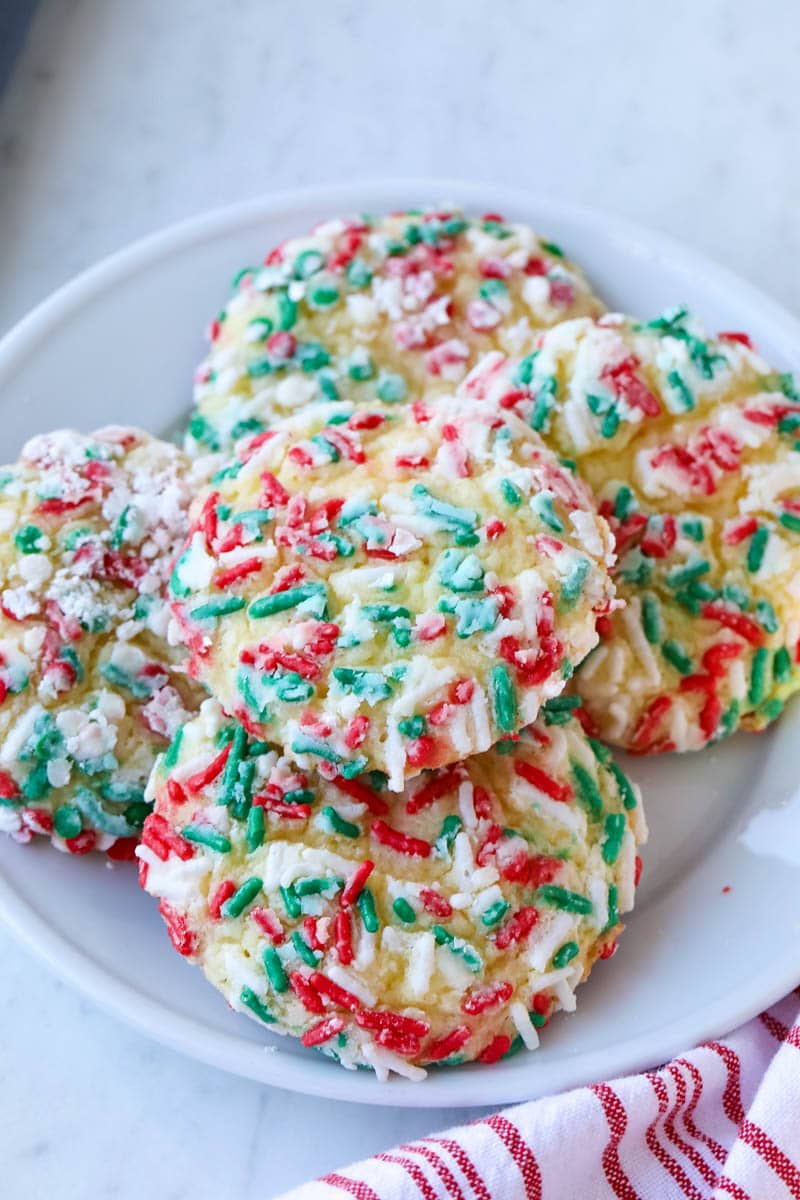 christmas cookies with sprinkles on a white plate 