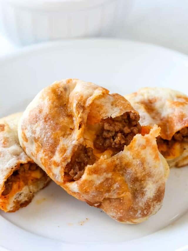 taco sticks stuffed with beef and cheese cut in half on white plate