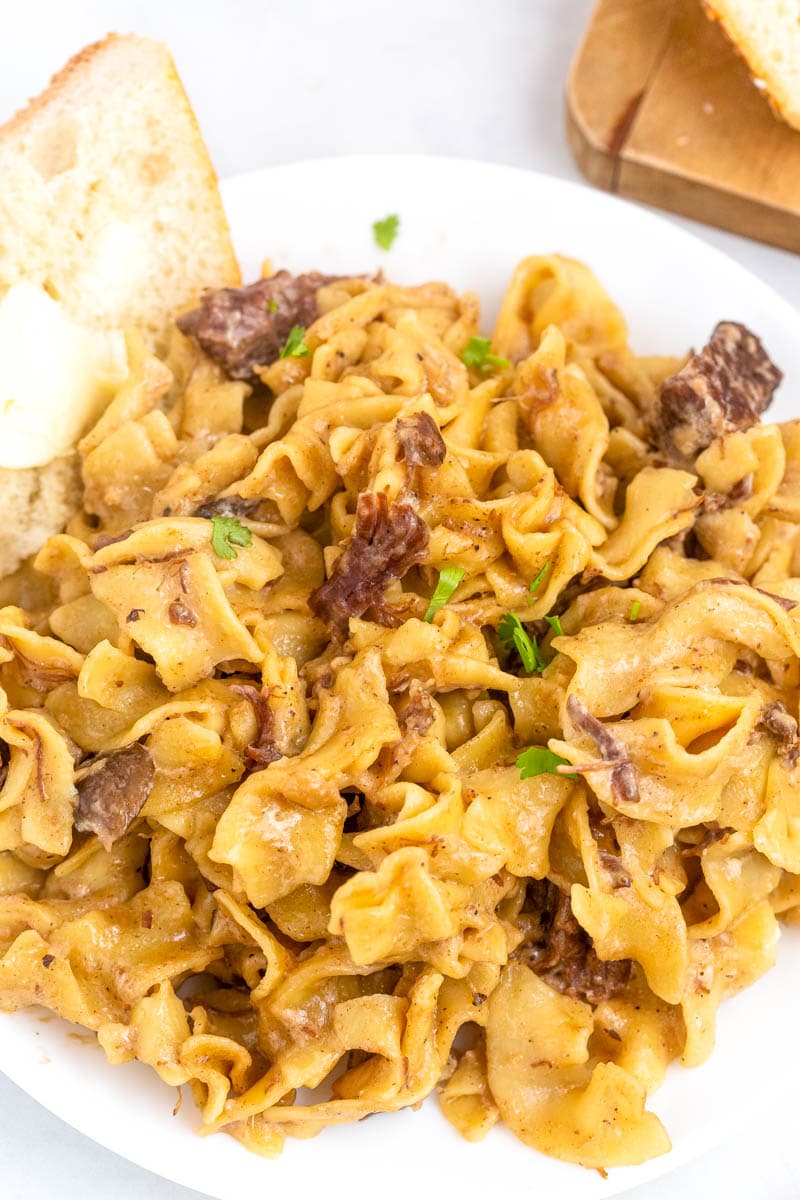 plate of stroganoff with bread 