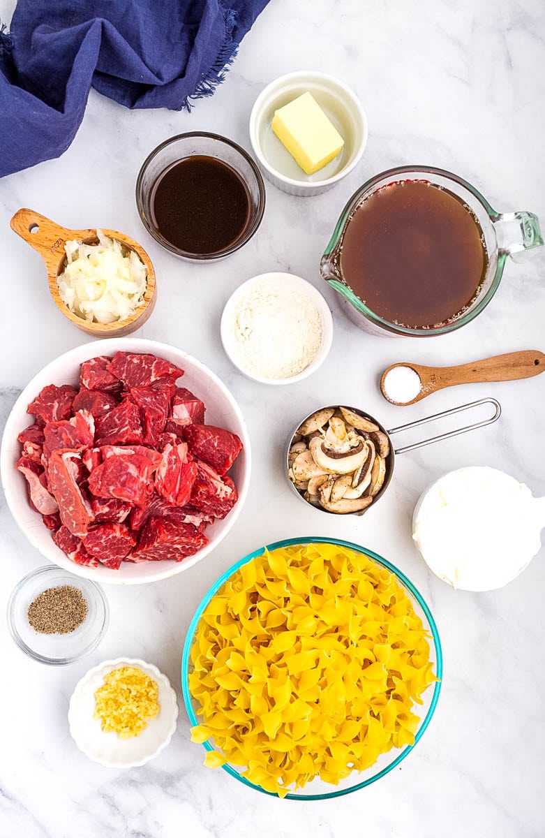 top shot of beef stroganoff ingredients in small bowls on countertop