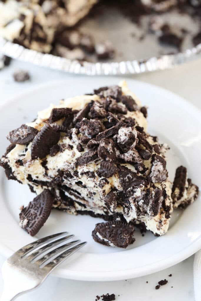 top shot of slice of oreo pie on white plate with fork