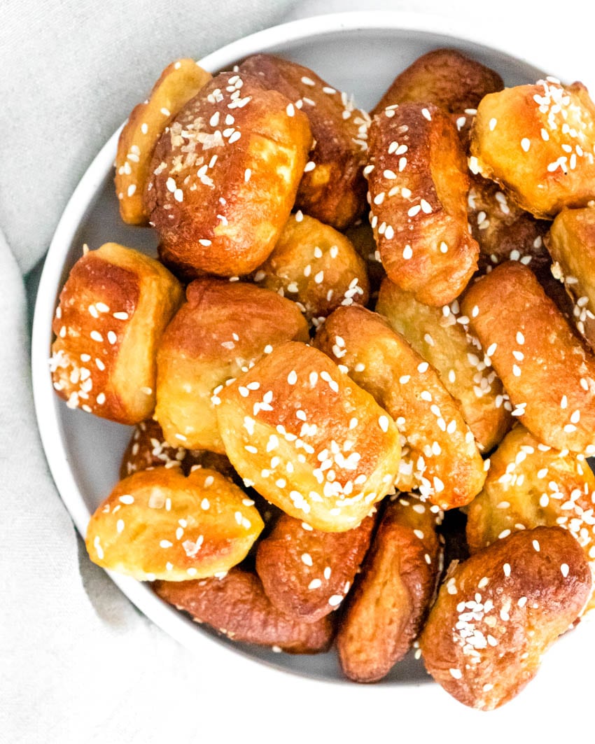 Small pretzel bites topped with kosher salt in white bowl