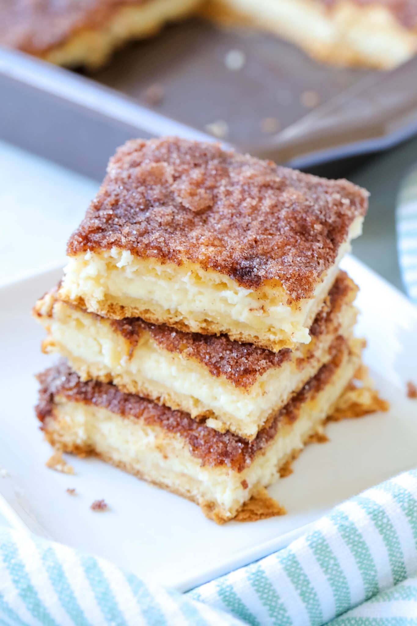 sopapilla cheesecake bars stacked on top of one another 