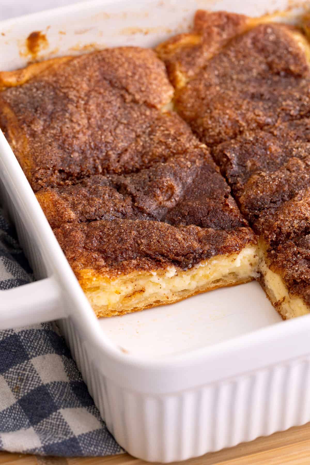 Sliced sopapilla cheesecake in baking dish.