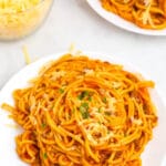 top shot of spaghetti in red meat sauce on white plate