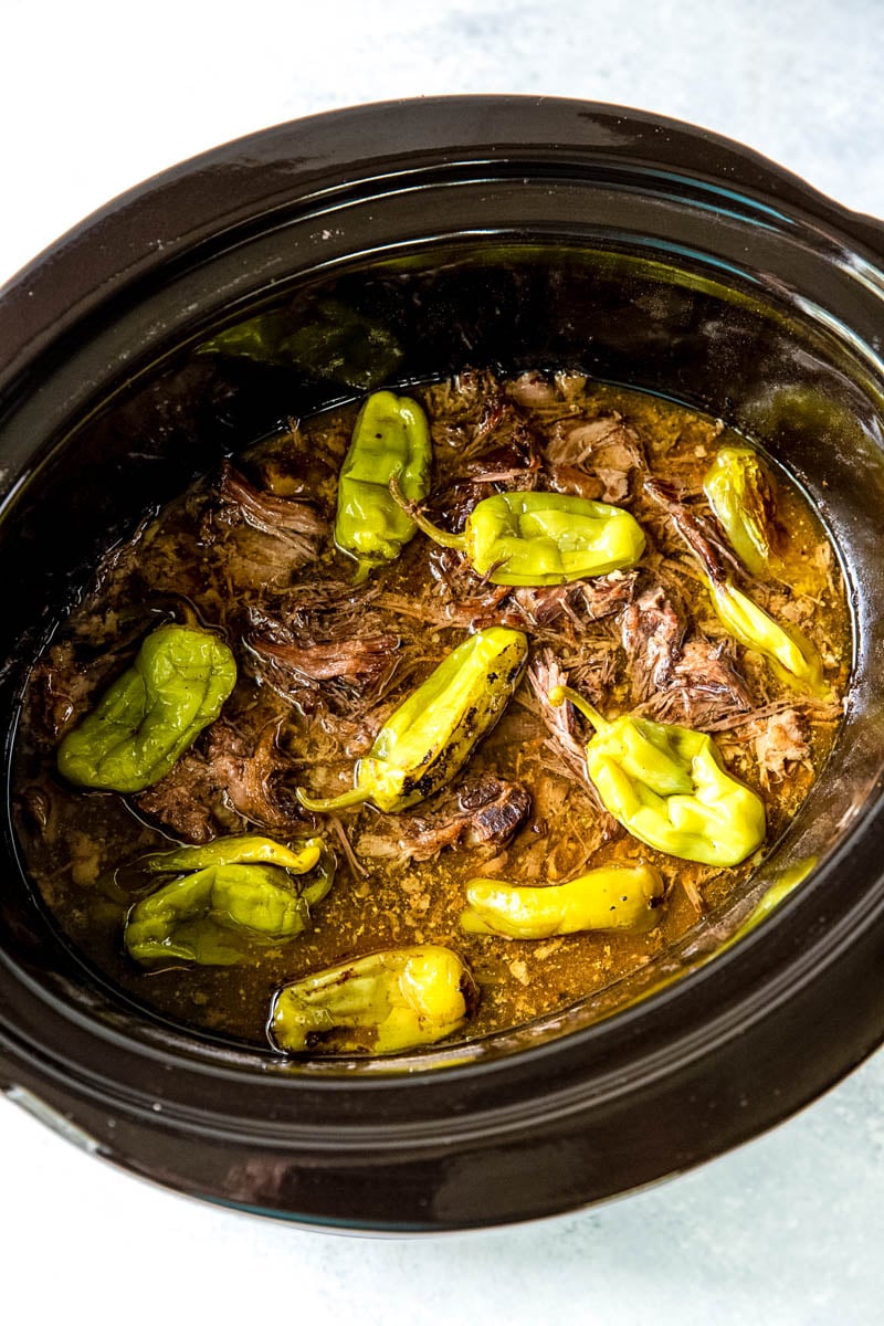 shredded beef and banana peppers in the slow cooker 