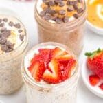 overnight oats with chia seeds in mason jar with spoon, topped with sliced strawberries.