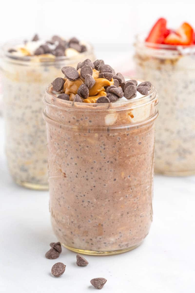 chia seed and oat mixture in mason jar topped with peanut butter and chocolate chips