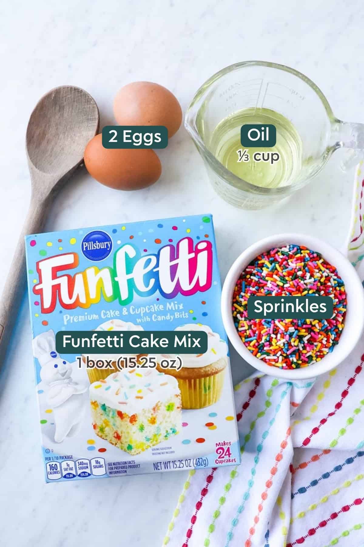 Ingredients for funfetti cookies, including oil, eggs, cake mix, sprinkles.
