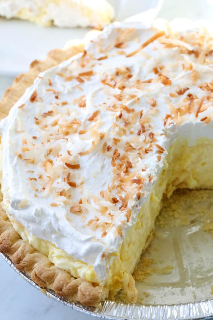 coconut pie topped with whipped cream 