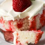 strawberry jelly poke cake on a white plate
