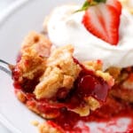 piece of dump cake topped with fresh strawberry