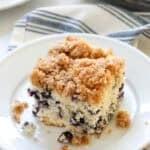 A slice of blueberry buckle cake on a plate.
