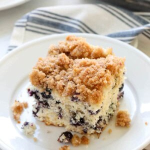A slice of blueberry buckle cake on a plate.