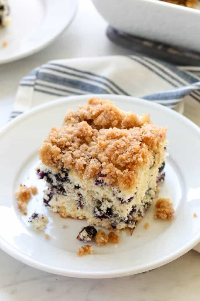 A slice of blueberry buckle cake on a plate.