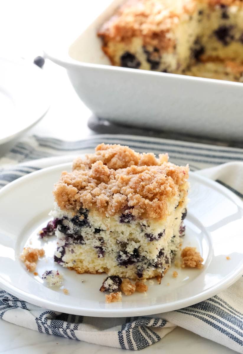 coffee cake on a white plate with a blue and white napkin.
