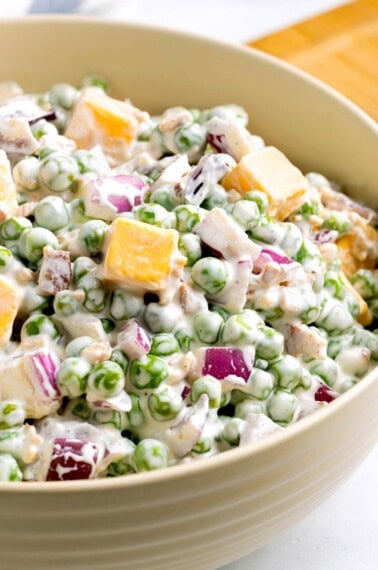 Pea salad in a bowl on a countertop ready for serving.