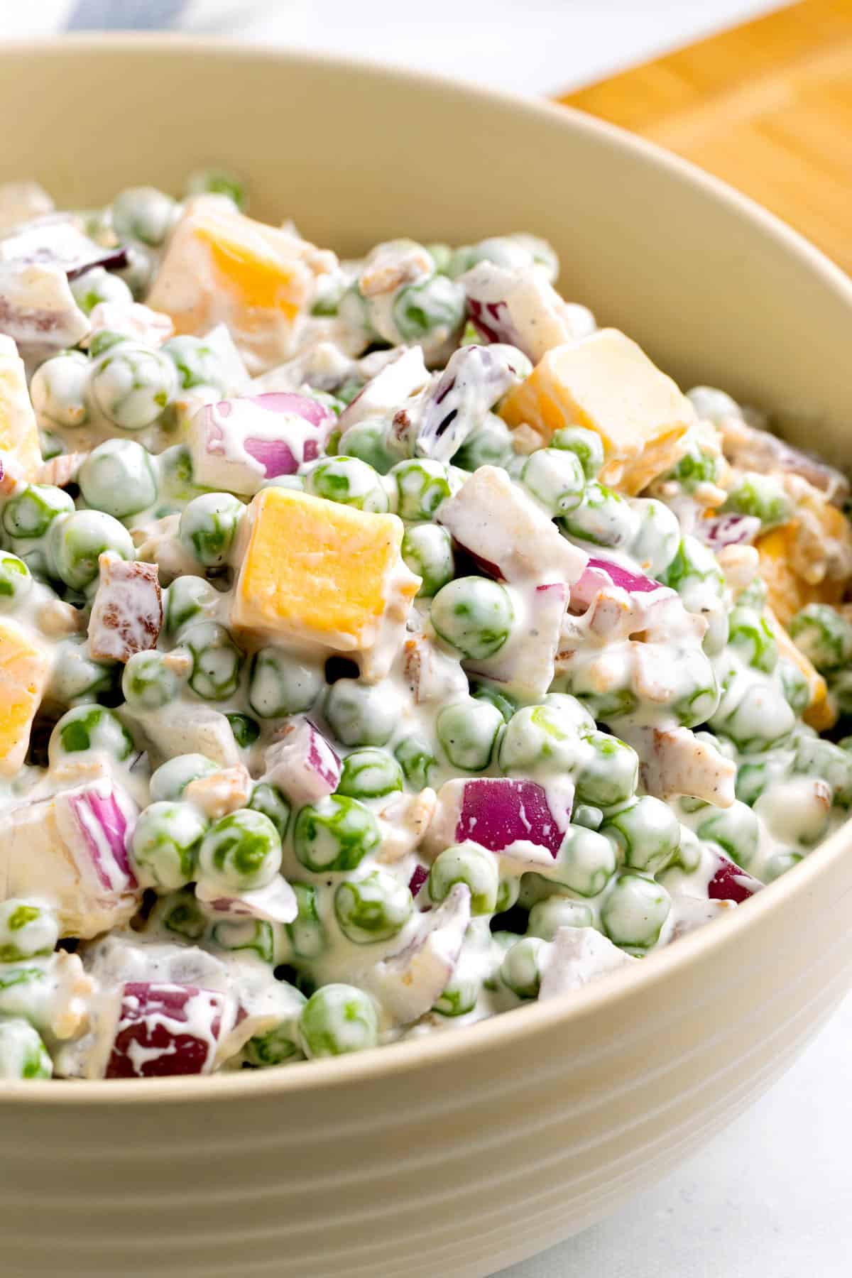 Pea salad in a bowl on a countertop ready for serving.