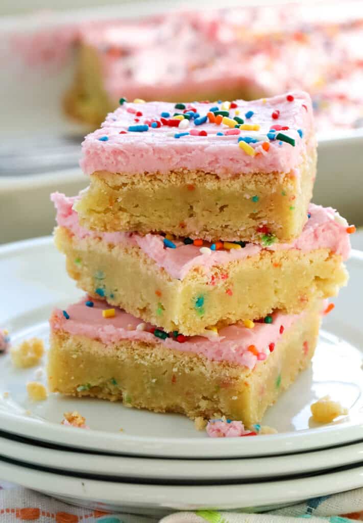 funfetti bars with cake mix on a white plate stacked