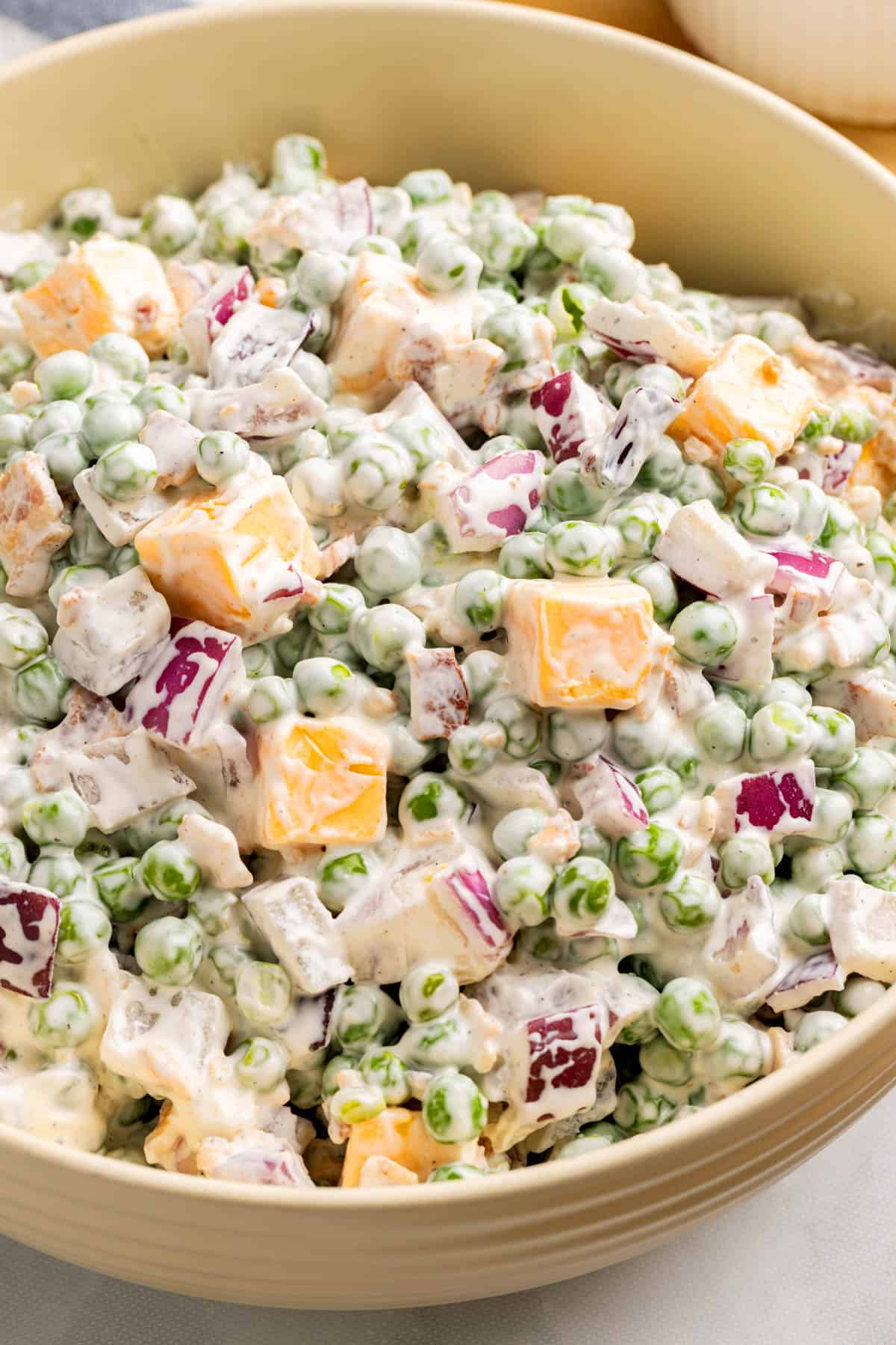 Sweet pea salad in a bowl on a countertop.