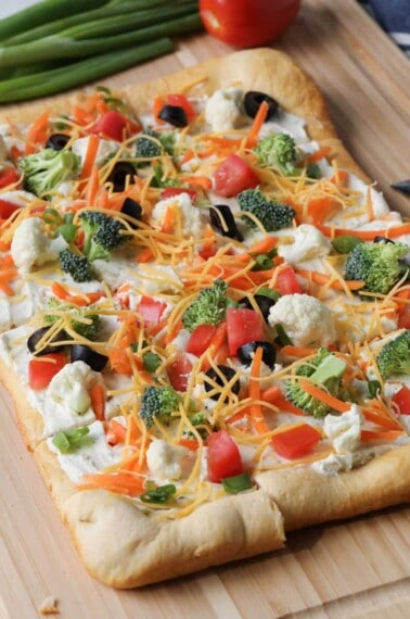 square veggie pizza on a cutting board