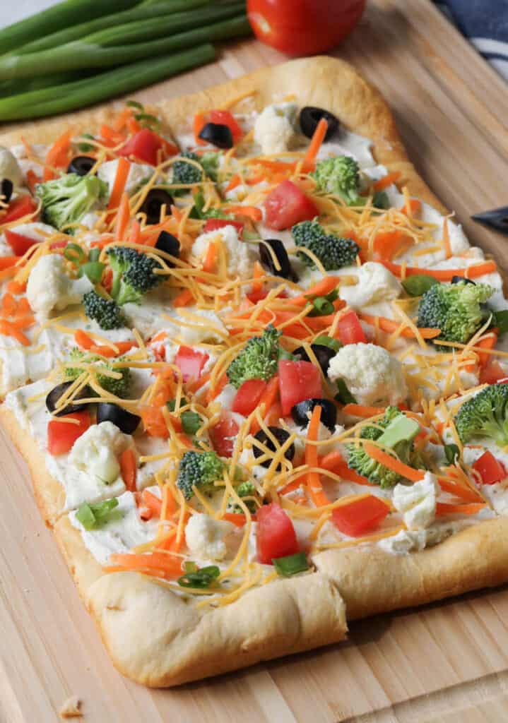 square veggie pizza on a cutting board 