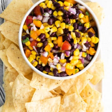 Overhead shot of Black Bean and Corn Salsa in bowl with tortilla chips