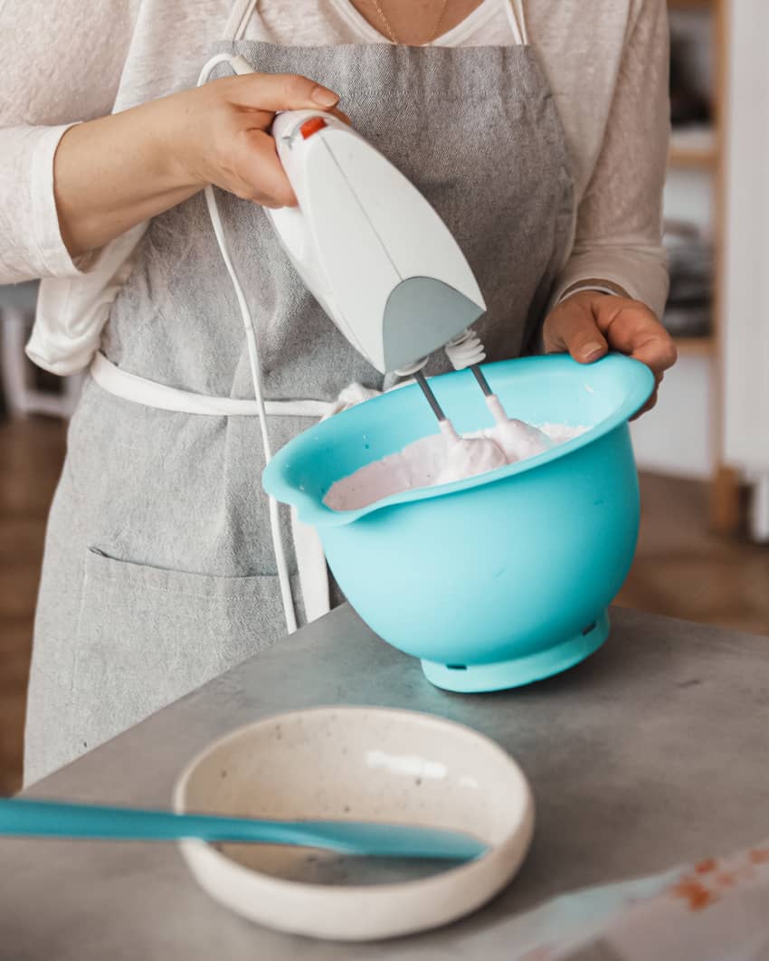 making ice cream with a hand mixer in a blue bowl
