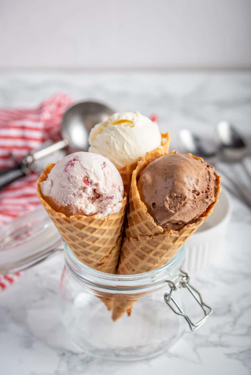 strawberry, vanilla, chocolate ice cream woth waffle cone on marble stone backgrounds