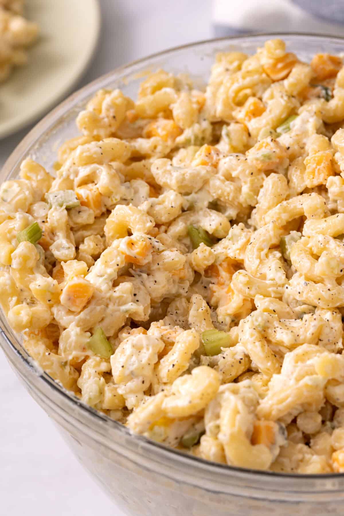 Macaroni salad in glass bowl.
