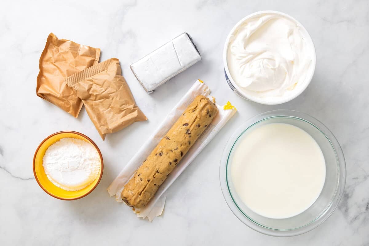 Ingredients for chocolate delight, including milk, pudding, cream cheese, cookie dough, whipped topping, sugar.