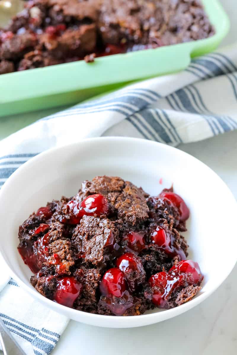 chocolate cherry dump cake in a white bowl on a table