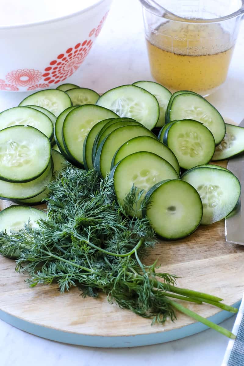 cucumbers, fresh herbs, dressing, on a table