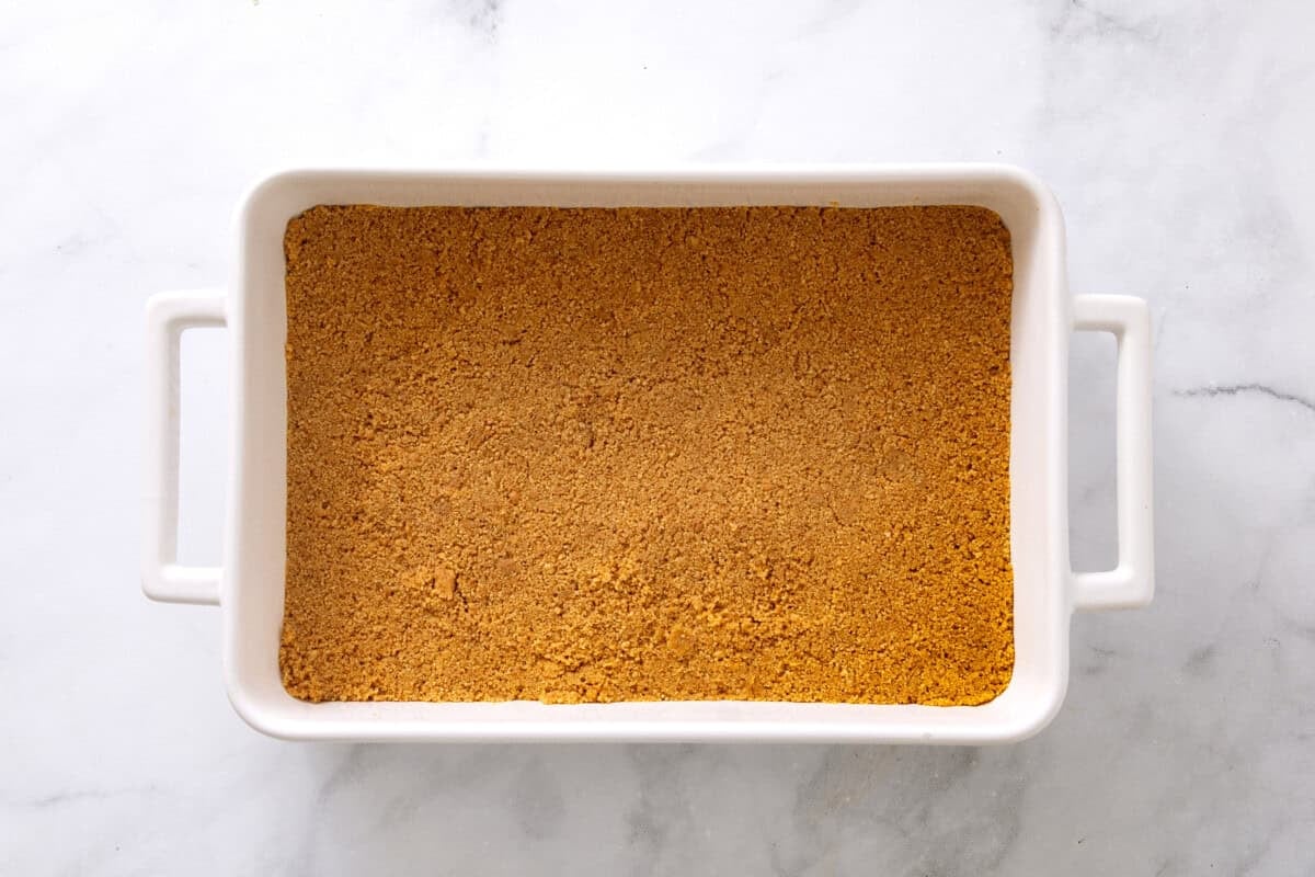 Graham cracker crust in rectangular baking dish.