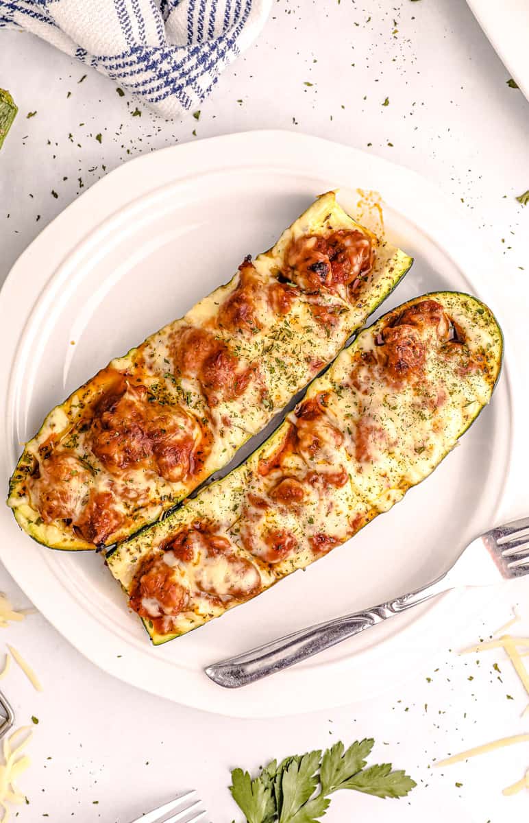 stuffed zucchini boats with a fork 