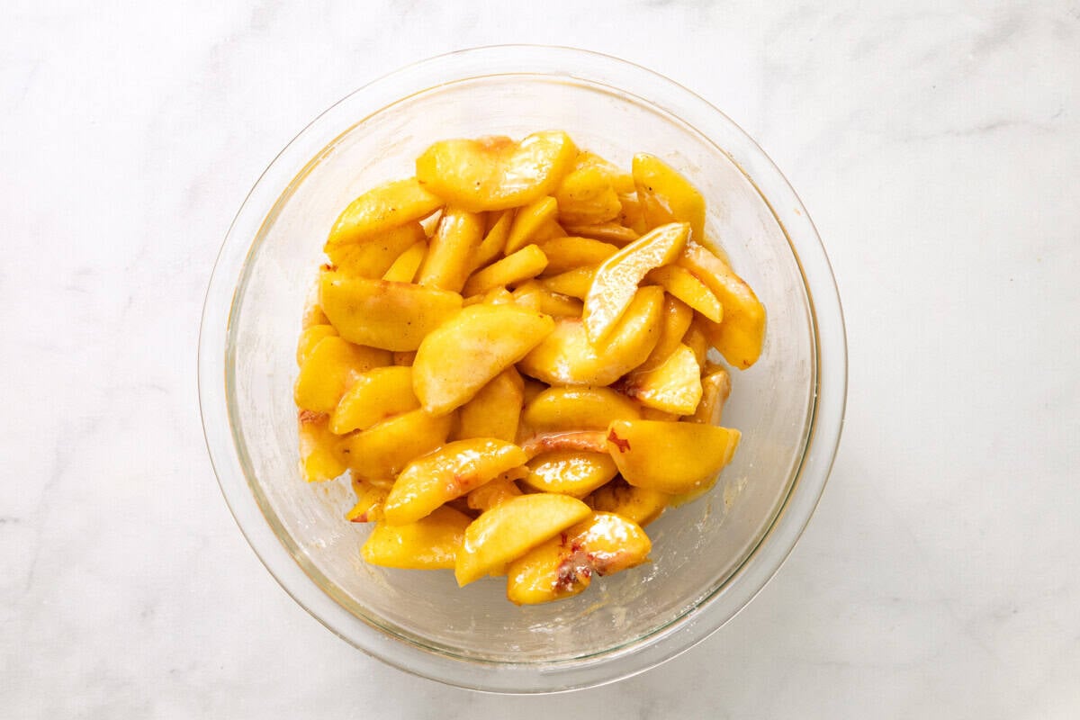 Peach pie filling in glass bowl.