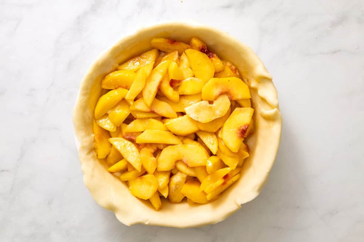 Peaches added to pie crust.