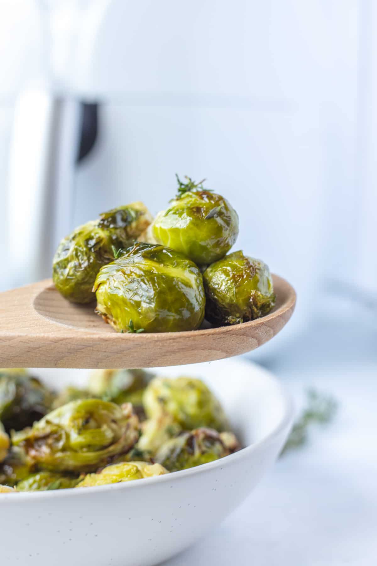 air fryer brussels sprouts on a wooden spoon