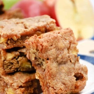 Apple blondies stacked on a plate.