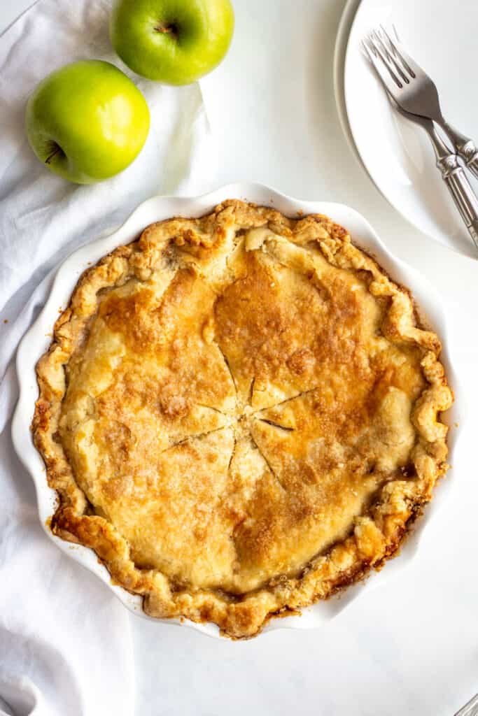 apple pie served in a white dish