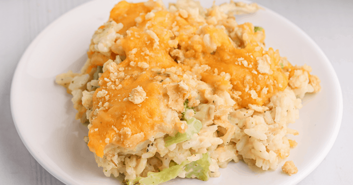 close up image of chicken and rice casserole served on a white plate.