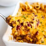 scoop of frito pie topped with shredded cheese
