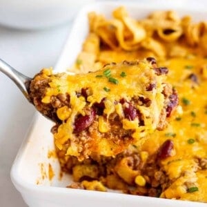 scoop of frito pie topped with shredded cheese