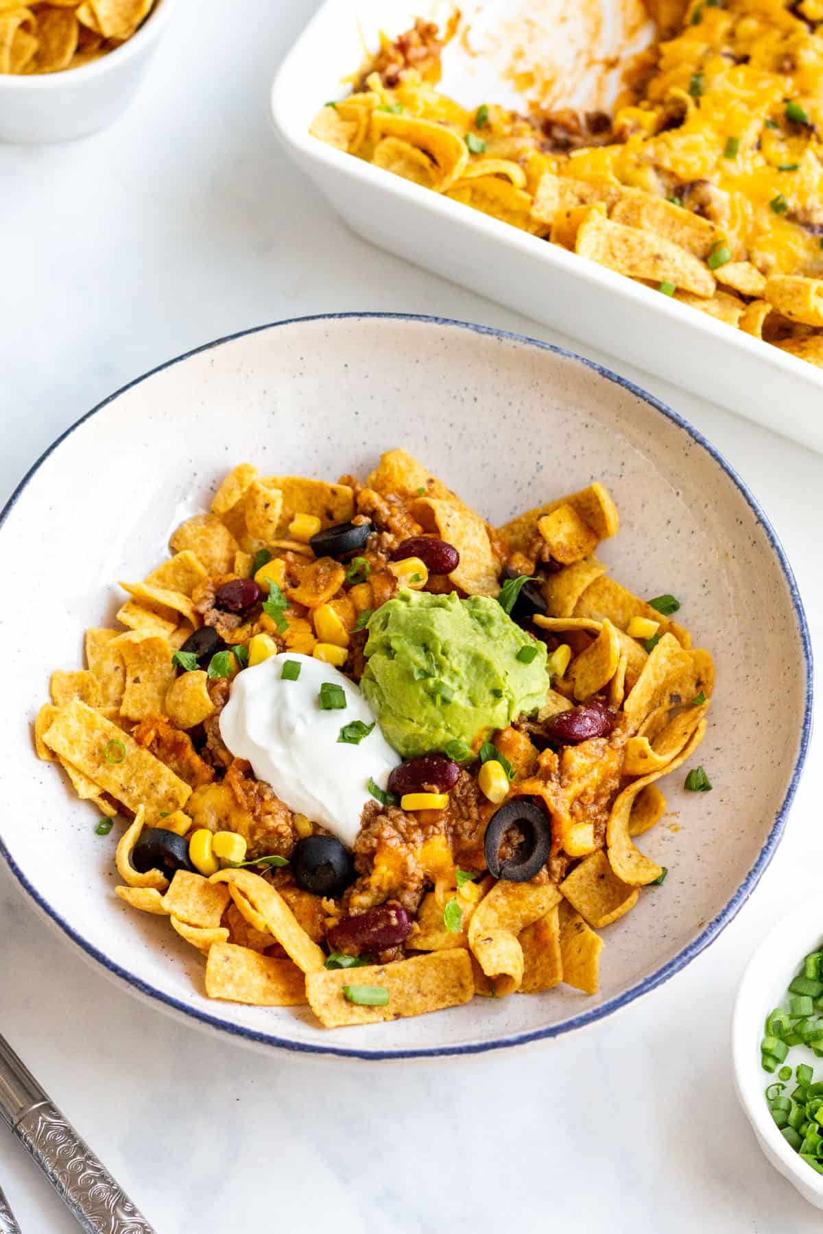 frito pie casserole in a white bowl on a table