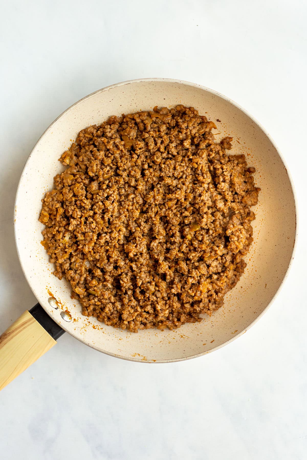 Browned ground beef in skillet.
